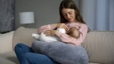A woman breastfeeding her new born baby